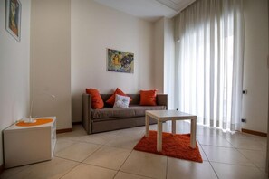 A modern living room with a sofa, a coffee table, and a side table.
