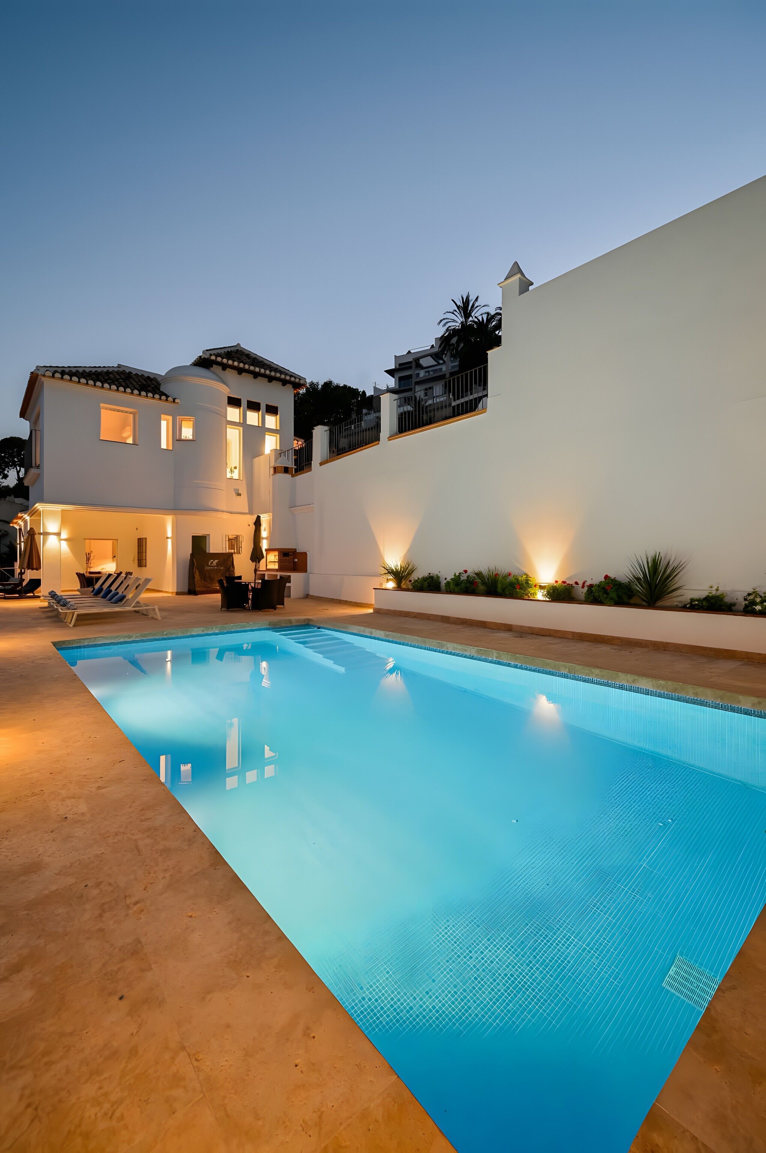 A swimming pool with a white building in the background.