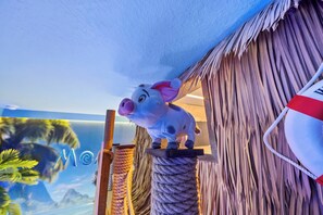 Ein Sparschwein auf einer Seilleiter vor einer strukturierten Wand.