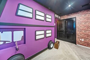 A purple double-decker bus-shaped room with a brick wall and a door labeled 'NIGHT BUS'. - 8BR house with private pool in clermont (Clermont)