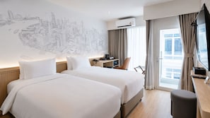 A hotel room with two beds, a desk, a chair, an air conditioning unit, and a cityscape mural on the wall. - Surestay By Best Western Siriraj Bangkok (Bangkok)