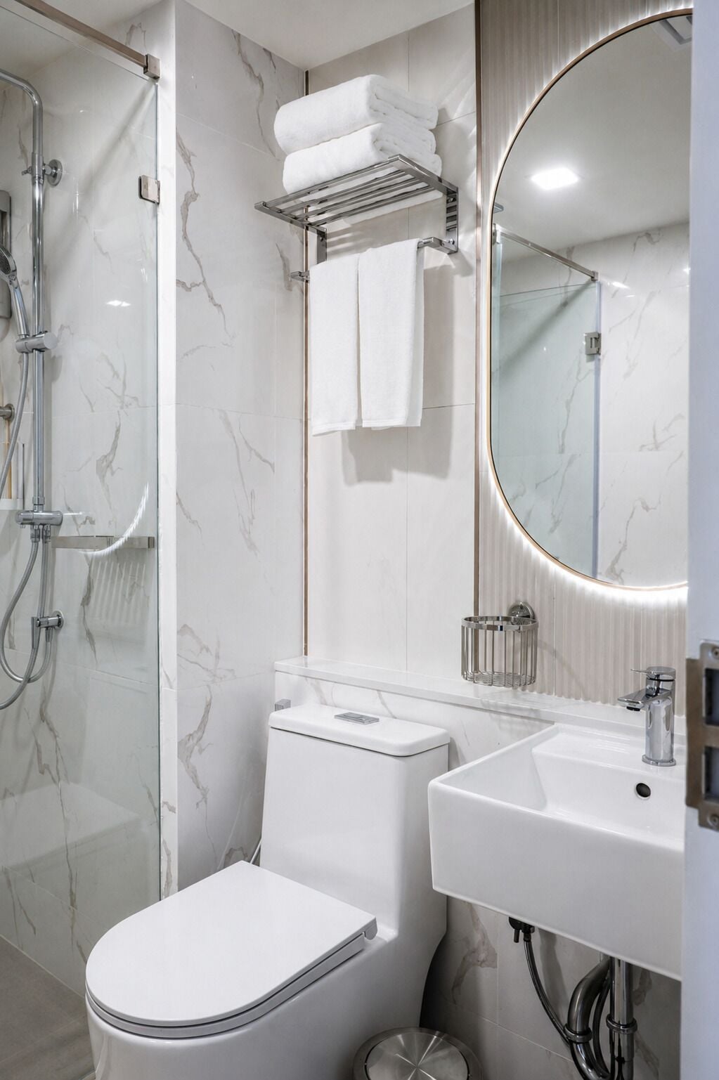 A modern bathroom with a toilet, sink, and shower.