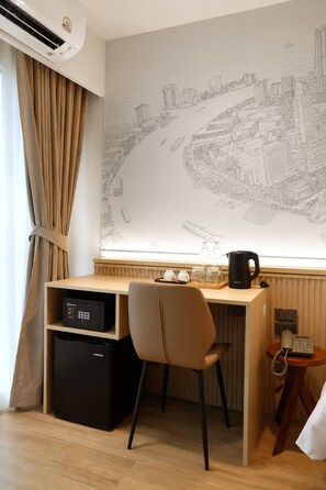 A hotel room with a desk, chair, and a large cityscape wall art. - Surestay By Best Western Siriraj Bangkok (Bangkok)