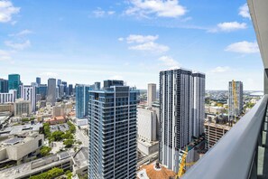 A high-rise building with a modern architectural design, featuring a prominent vertical structure and a mix of glass and concrete facades. - Bright Downtown Apt with Balcony and Bay Views - G3108 (Miami Beach)