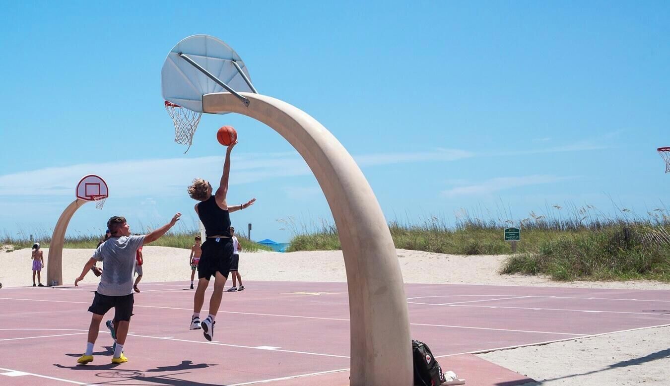 Una cancha de baloncesto al aire libre con una estructura de aro curva.