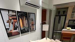 A modern bedroom with a bed, a desk, and a chair.