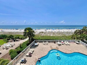 A pool area with lounge chairs and a view of the beach. - Marlin Key 2B Your Gulf-front Escape in Beautiful Orange Beach, Alabama (Orange Beach)