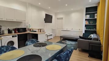 A compact living space with a kitchen, dining area, and seating area.