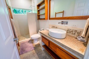 A bathroom with a round sink, wooden vanity, a toilet, and a shower area. - Spacious 5BR Villa w Saltwater Pool Yoga Deck 4-min Walk to Garza Beach (Nosara)