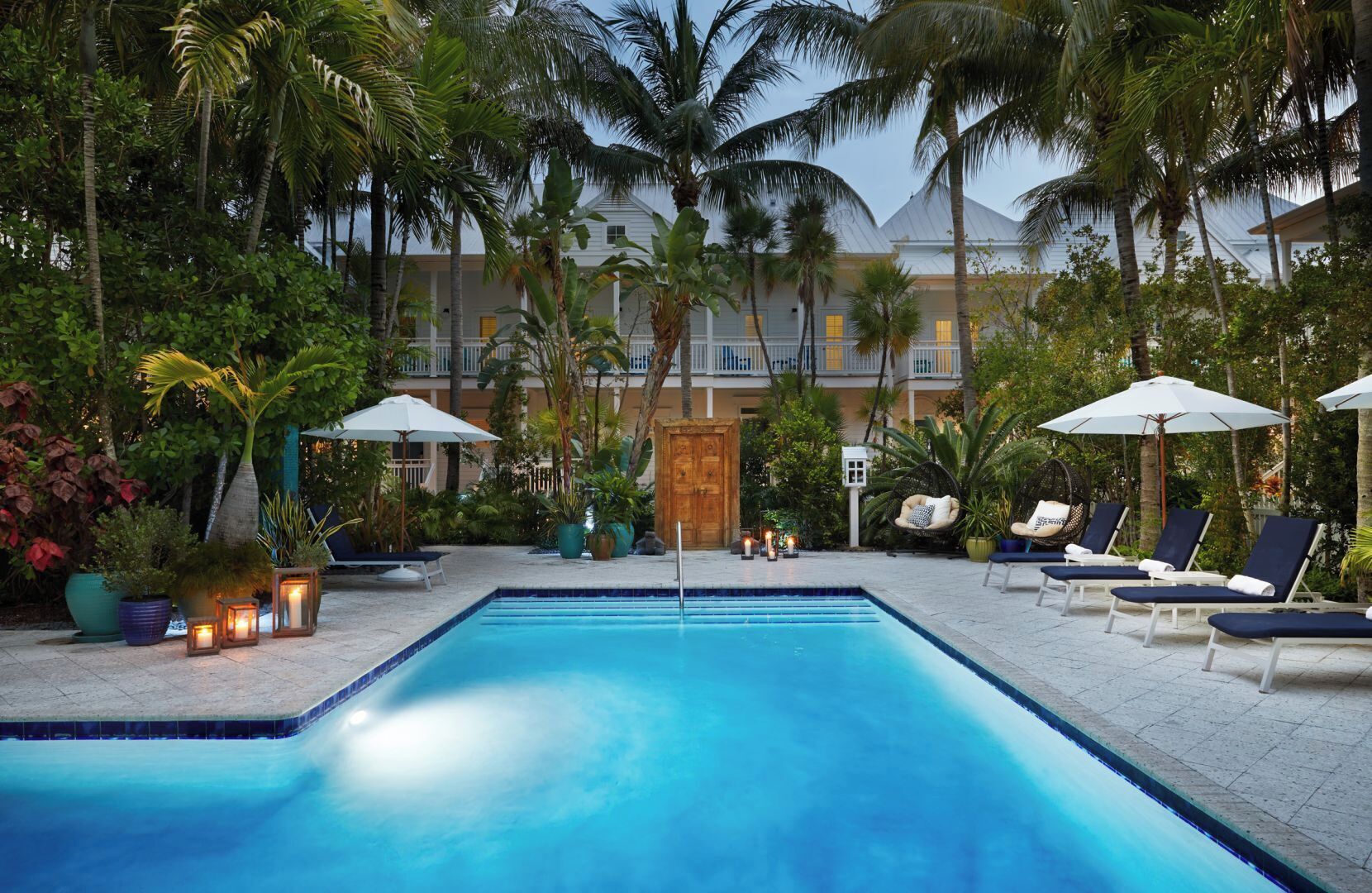 Slip into an evening swim with lantern-lit tropical serenity.