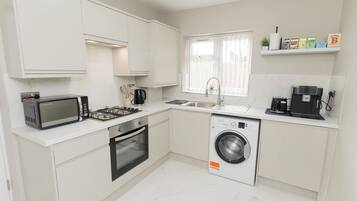 Coffee/tea maker, fridge, microwave, oven
