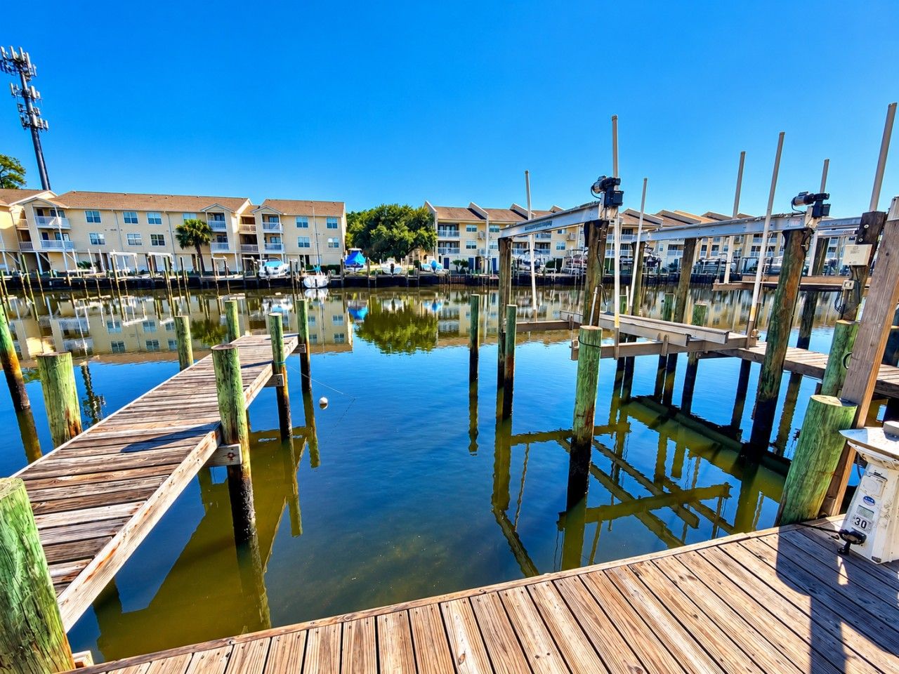 A marina with wooden docks and buildings in the background.