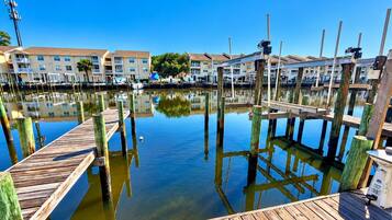 A marina with wooden docks and buildings in the background.