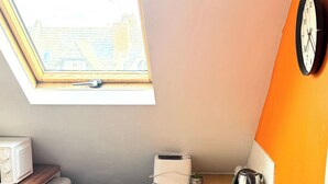A compact kitchen with a washing machine, a toaster, and a small window. - Apartment Sleeps 6 With Wifi in Willesden Green (London)