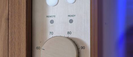 A control panel with temperature settings, remote control, and mood lighting options.
