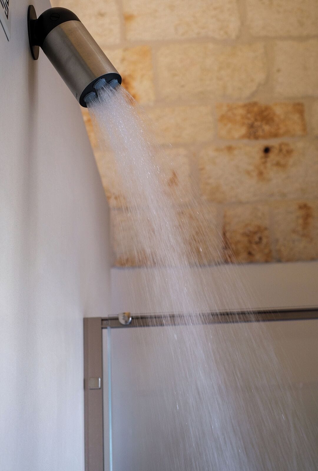 A wall-mounted water feature with a clear stream of water flowing down.
