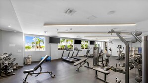 A gym with treadmills, weight machines, and exercise balls. - Sleek Miami 2BR | Free parking | Pool & Gym (Miami)