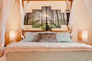 A four-poster bed with a forest-themed artwork above it, a canopy, and two bedside lamps. - Exposed Beam Getaway - Heart of NH White Mountains (Thornton)