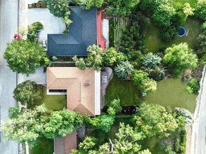 A residential property with a sloped roof, a fenced yard, and a small pond. - 8-BR Luxury Home Near Little Cottonwood Canyon (Sandy)