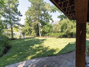 A well-maintained lawn with a stone pathway leading to a wooden pergola structure. - 8-BR Luxury Home Near Little Cottonwood Canyon (Sandy)