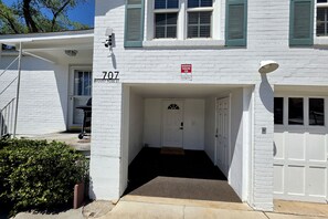 A white building with a number 707 sign, a reserved parking sign, and a covered entrance. - Mt Rose Retreat | Near Midtown & Downtown (Reno)