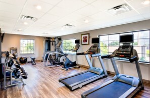A gym with treadmills, elliptical machines, and free weights. - Accessible 1BR Suite w/ Kitchen + Free Breakfast (Davie)