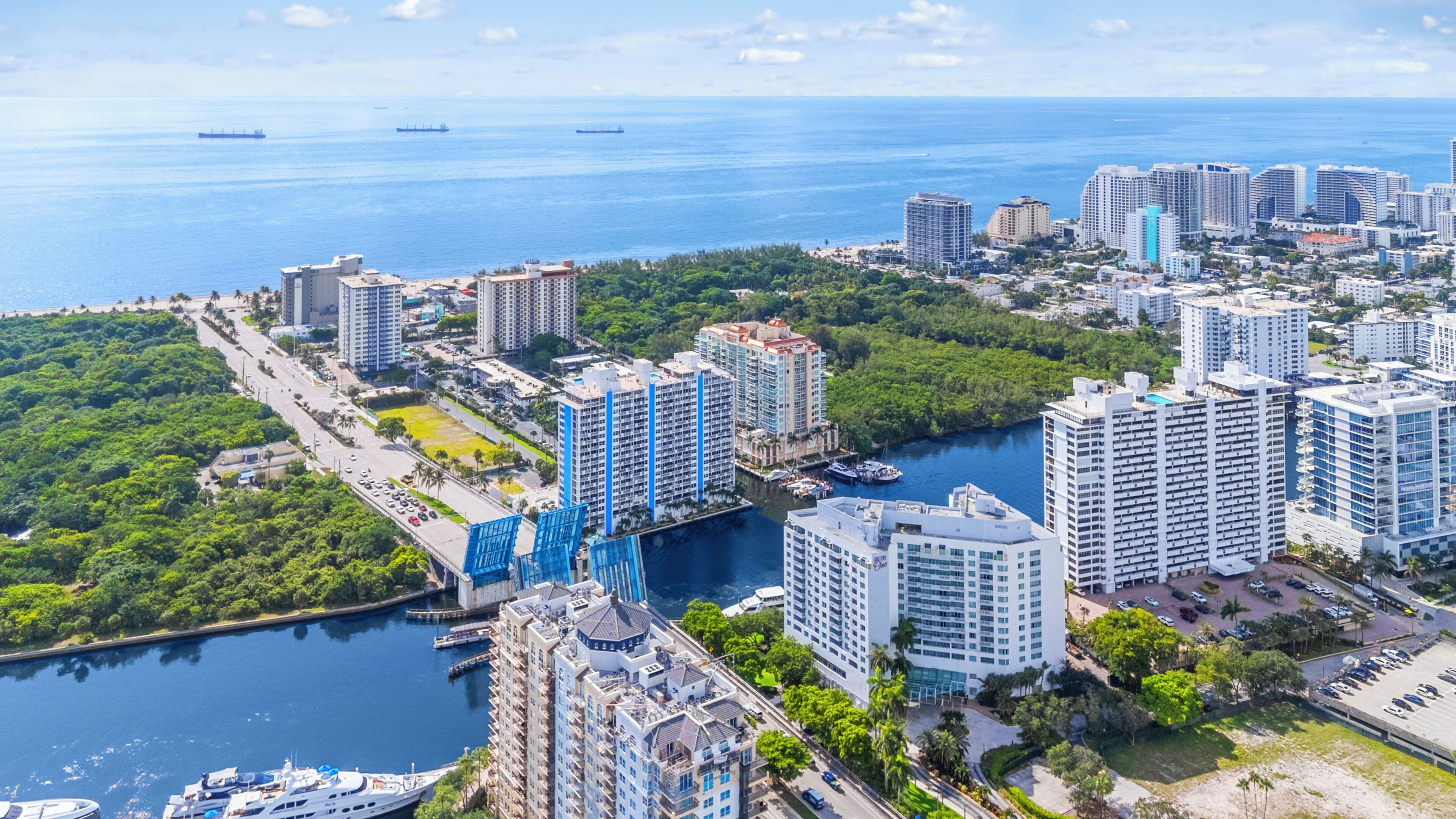 A high-rise hotel with a view of the sea and a marina.