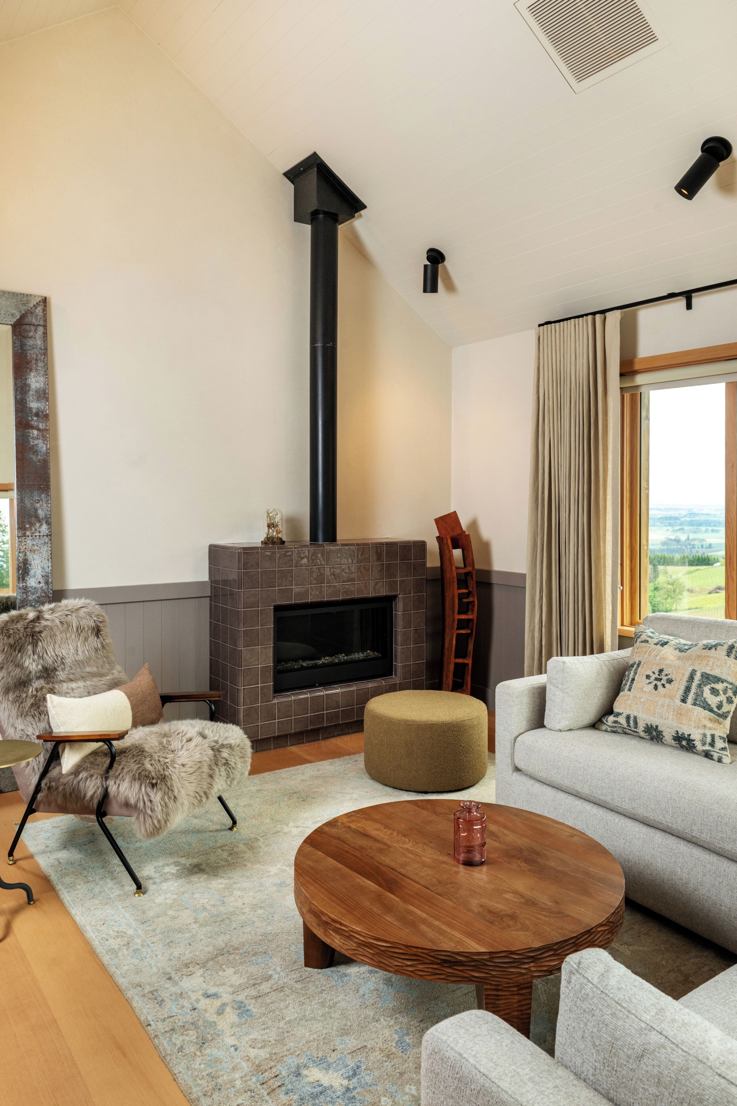 A living room with a fireplace, a sofa, a chair, and a coffee table.