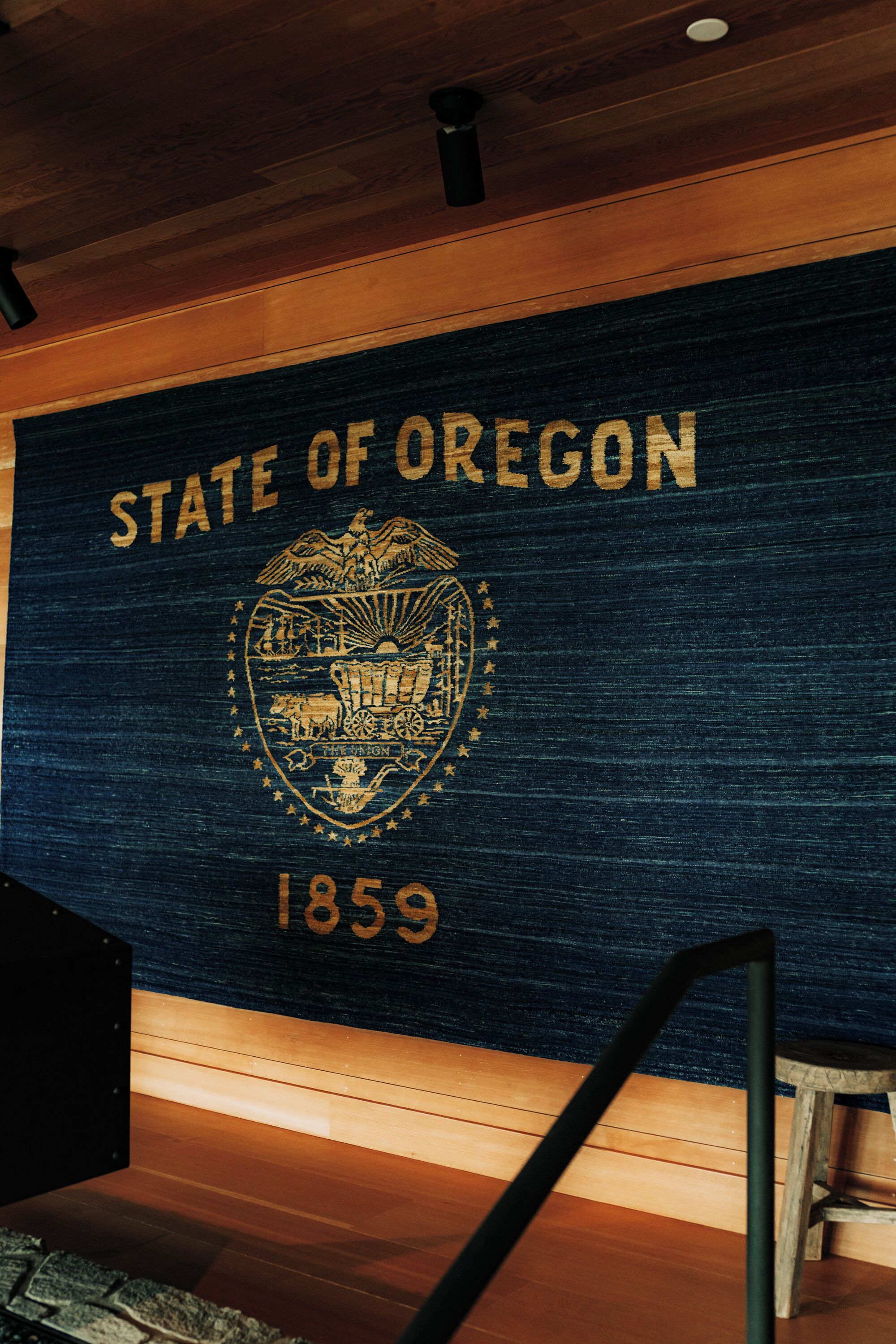 A wall with the text 'STATE OF OREGON 1859' and a coat of arms.