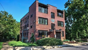 A two-story brick building with a sign that reads 'SABEL'. - Sabel #201 | Downtown Asheville king suite with parking, Wi-Fi, and smart TV. (Asheville)