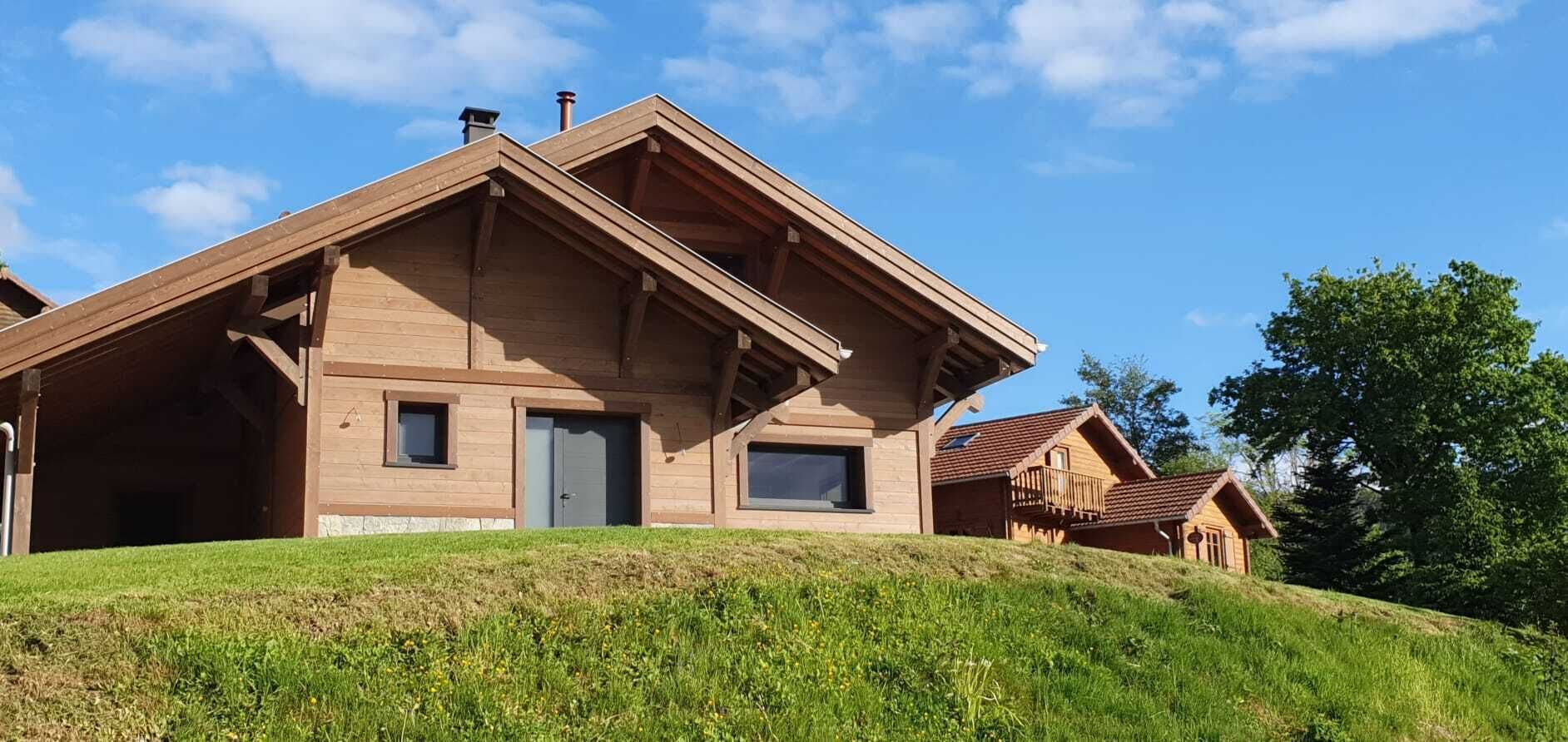 A wooden cabin with a sloped roof, a front door, and a small window.