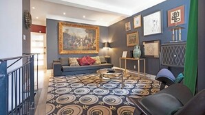 A modern living room with a sofa, a coffee table, and a patterned rug. - Designer 3BR • Two Levels • 2.5 BTHR (Montréal)
