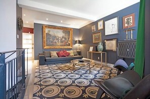 A modern living room with a sofa, a coffee table, and a patterned rug. - Designer 3BR • Two Levels • 2.5 BTHR (Montréal)