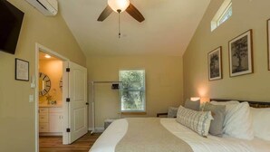 A bedroom with a bed, a ceiling fan, a window with blinds, and a door leading to a bathroom. - Ponerosa Nest-Quails Nest 1hr Drive to Yosemite (Mariposa County)