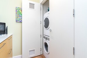 A laundry room with a washing machine, dryer, and microwave. - Vibrant Waterfront Living at The Janion (Victoria)