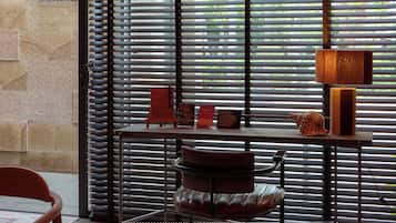 A modern interior with a large window, a starfish decoration, a table, and a chair.