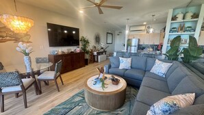A modern living room with a sofa, coffee table, and dining area. - Oceanfront, swim with turtles, enjoy sunset views, all from your backyard. #B18 (Lahaina)