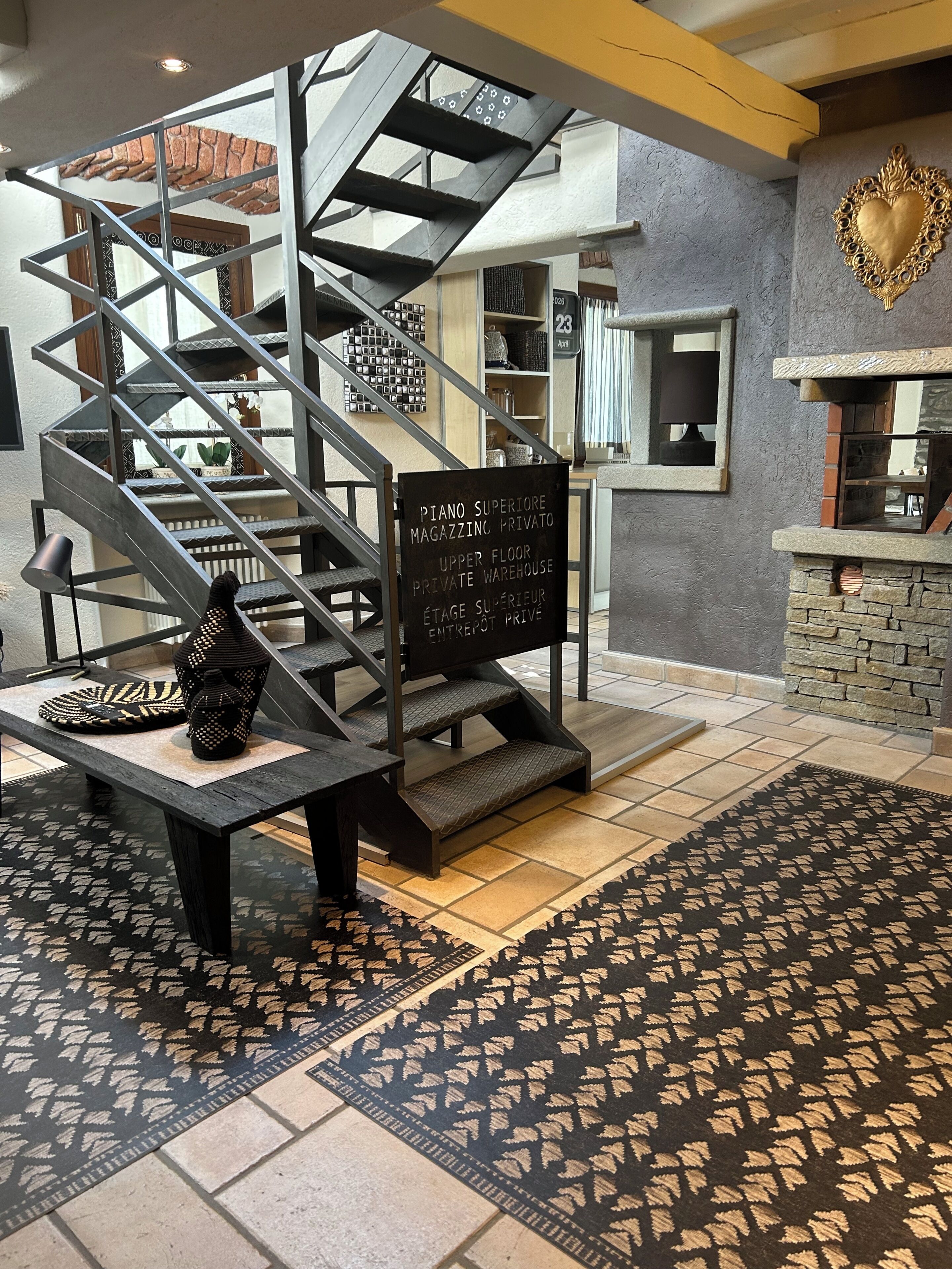 Eine Treppe führt zu einer oberen Etage, wo ein Schild auf ein privates Klaviergeschäft hinweist.