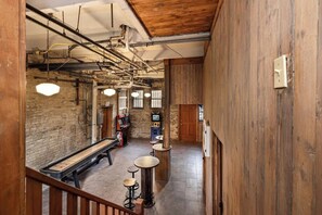 A spacious hall with a long bench, a small bar area, and a staircase. - 5BR Luxury Retreat With Huge Garage & 3 King Beds! (Milwaukee)