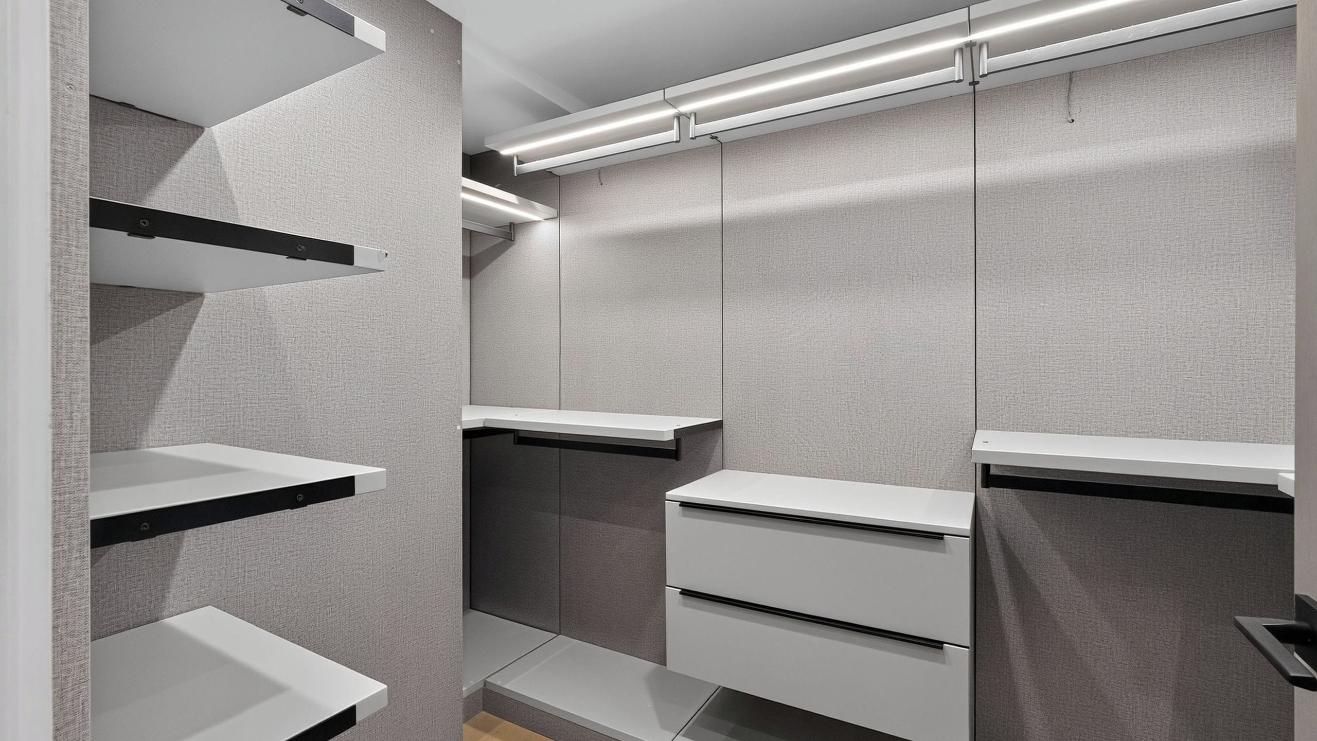 A modern bathroom with built-in shelves, a vanity, and a towel rack.