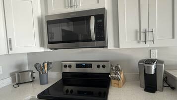 Coffee/tea maker, fridge, microwave, oven