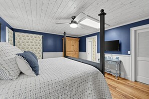 A bedroom with a bed, a wardrobe, a television, and a ceiling fan. - Mtn-View Cashiers Cottage w Screened Deck! (Glenville)