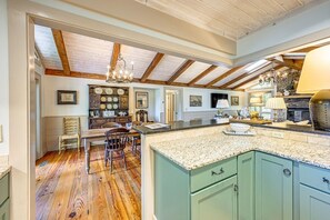 A kitchen with a wooden ceiling, granite countertops, and a stone fireplace. - Mtn-View Cashiers Cottage w Screened Deck! (Glenville)