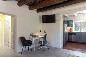 A modern kitchen with grey cabinets, a built-in oven, and a coffee maker on the counter. - Sunset Mountain Casita - 1 Bedroom (Santa Fe)