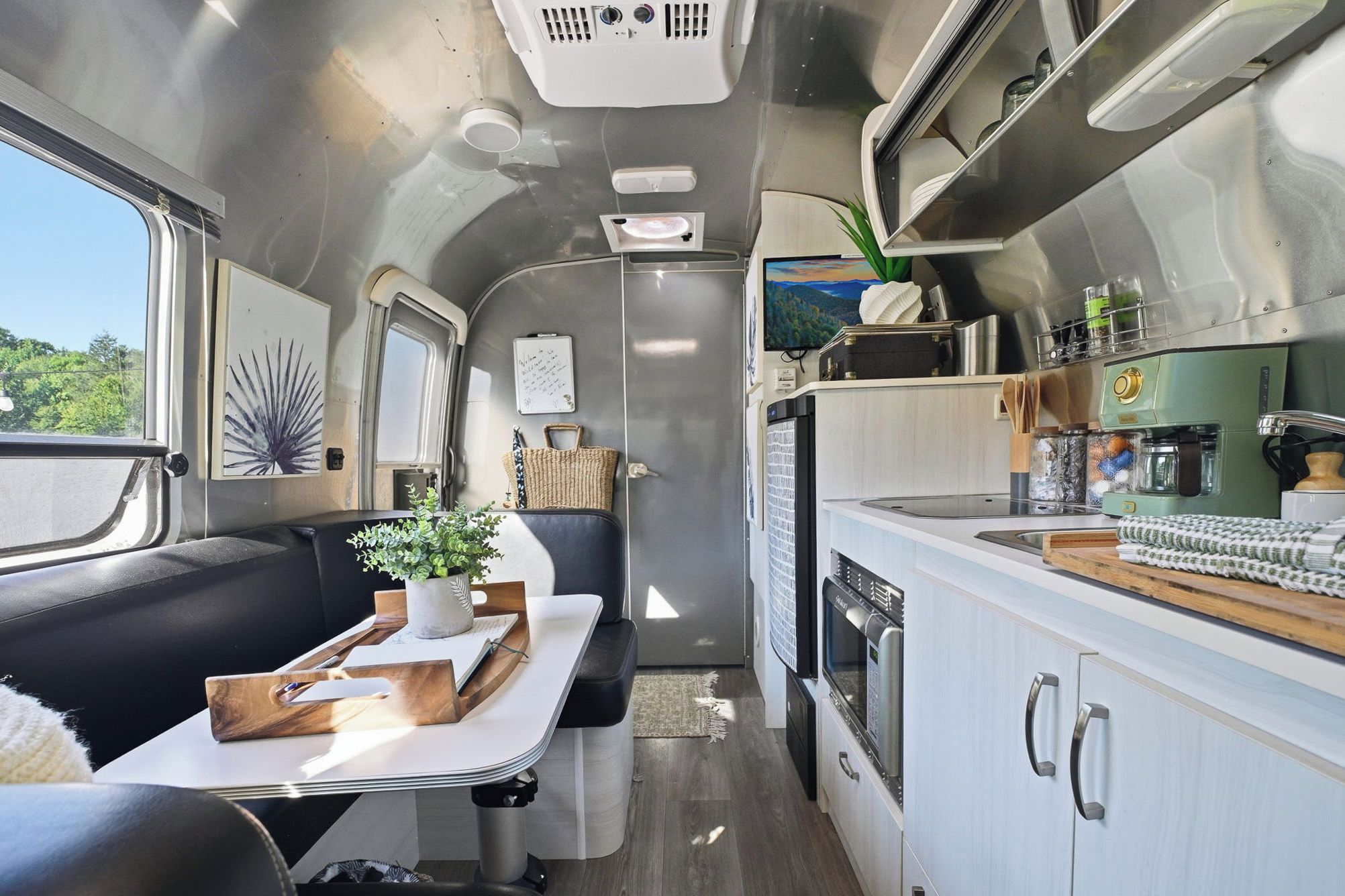 A compact kitchen with a stove, microwave, and a coffee maker.