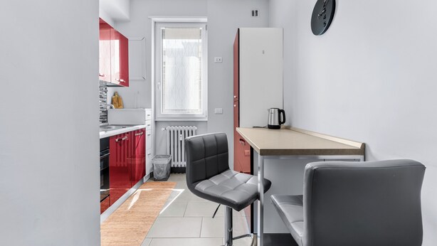 A compact kitchen with a window, a refrigerator, a coffee maker, and two bar stools. - Scarlatti31 - Beautiful apartment in the heart of Milan, Milan Central Station (Milano)