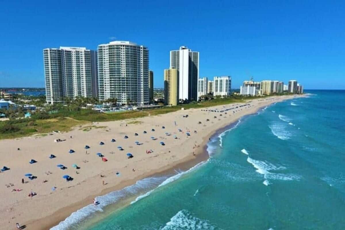 A beach with multiple high-rise buildings in the background.