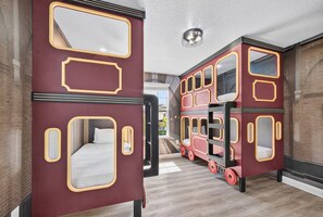 Double-decker beds with a mirrored wall and a ceiling light fixture. - The Epic Escape Mansion near Disney/Universal •Free Parking •5-Baths •25 Guests (Four Corners)