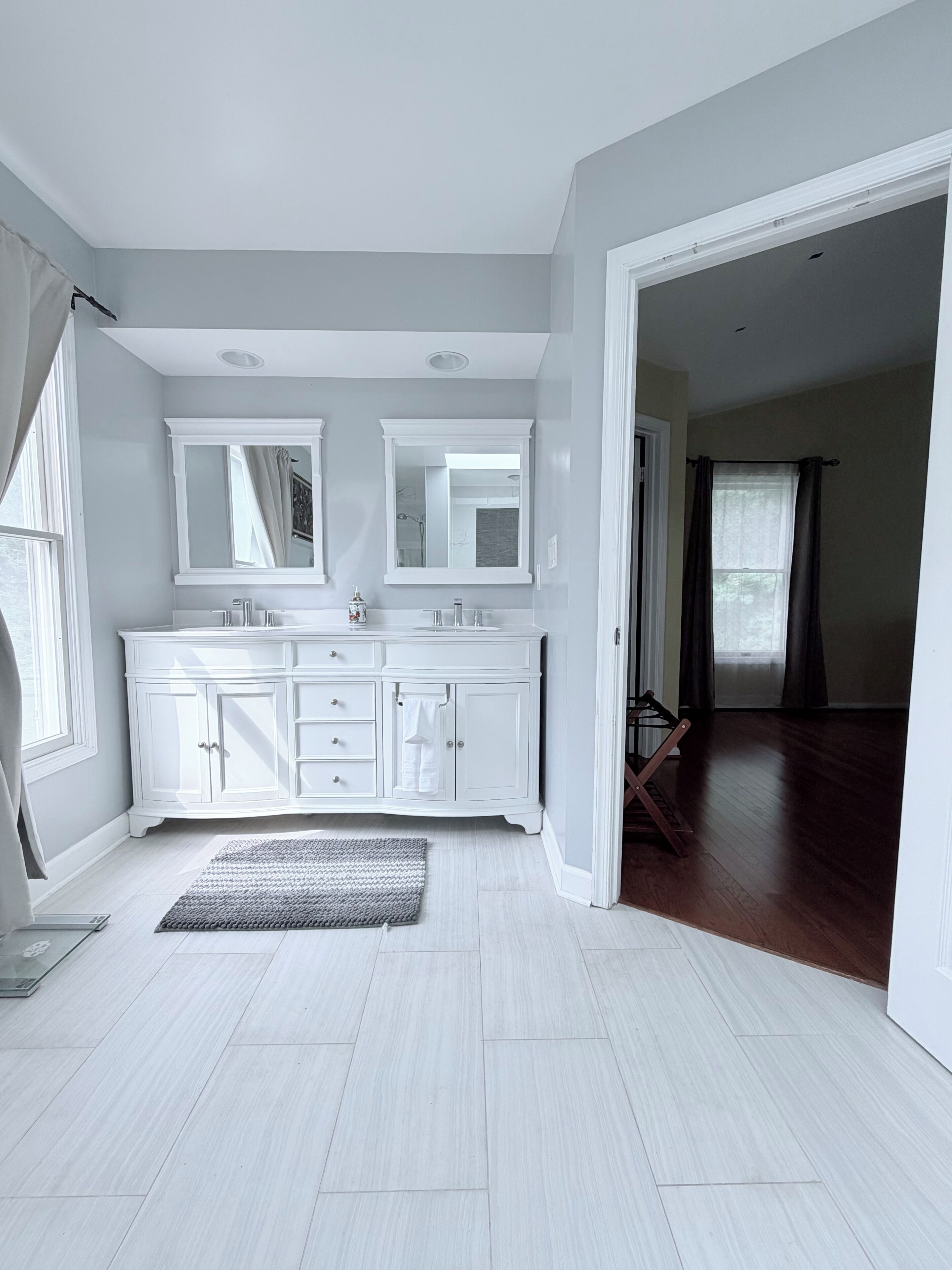 A spacious bathroom with a large vanity, double sinks, and a walk-in shower.