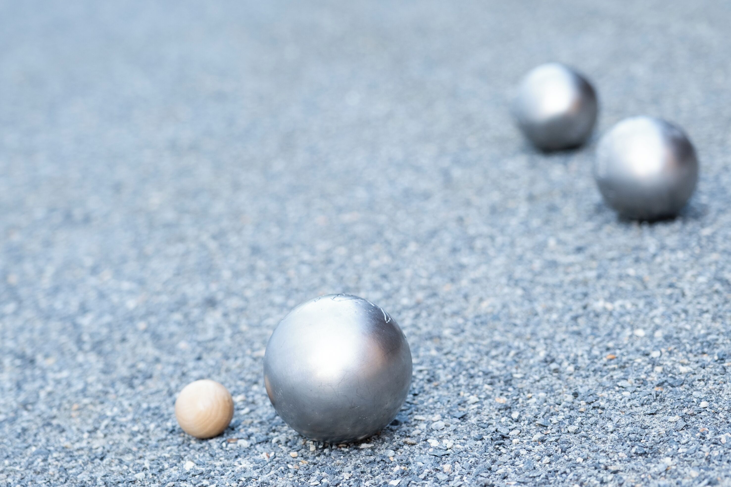 Four metallic spheres on a textured surface.